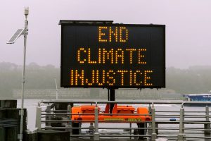 Foto av skilt som sier "End climate injustice"